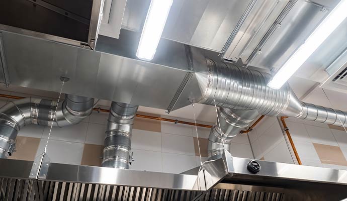A kitchen hood connects to metal ducts