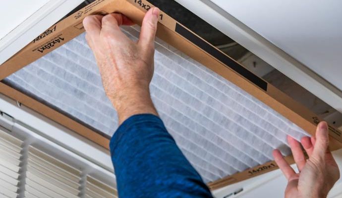 A man installing new air duct