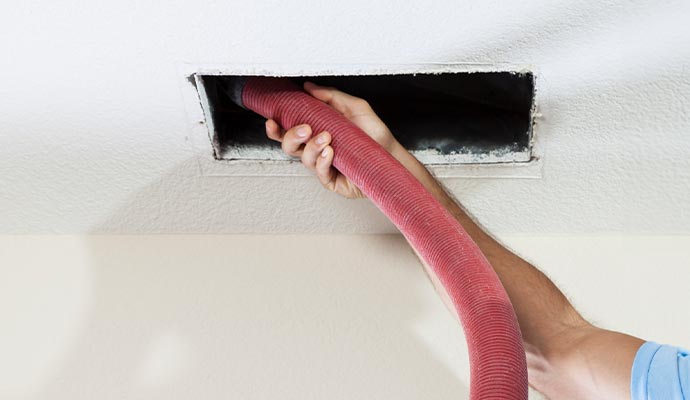 worker is cleaning air duct