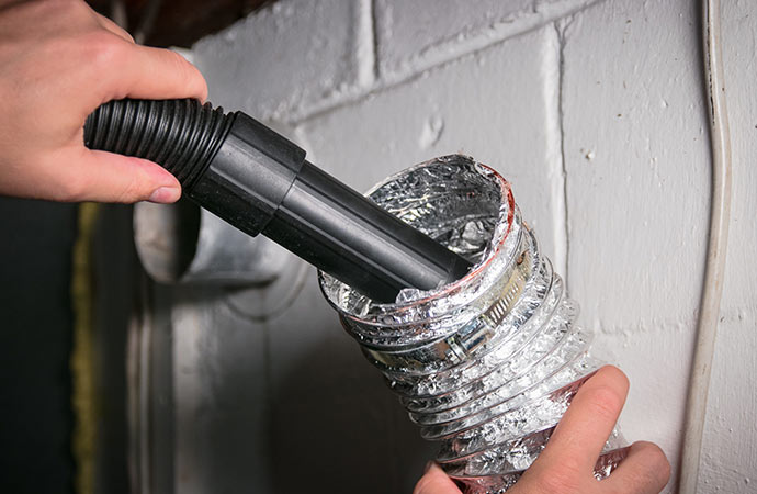 Professional worker cleaning duct pipe