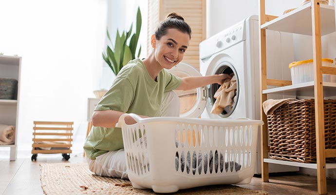 Person drying clothes using a washing machine.