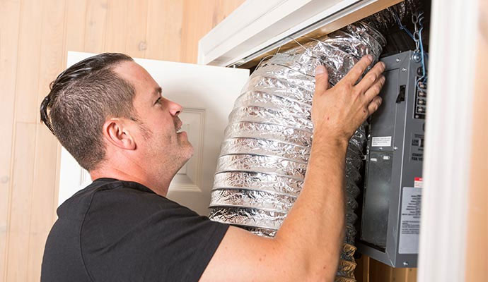 HVAC technician installing flexible air duct