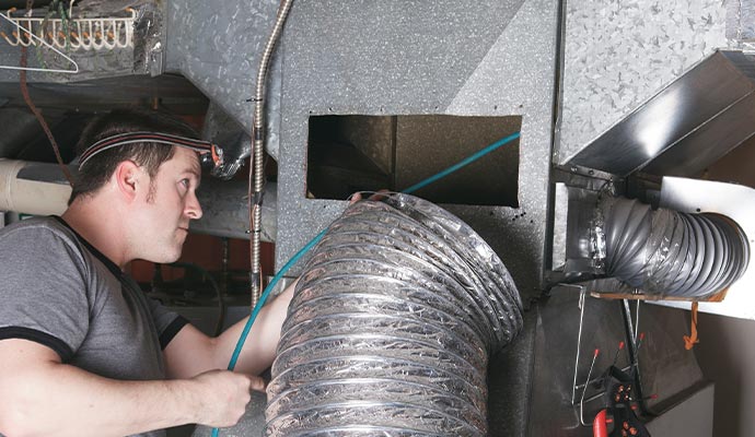 A professional cleaning HVAC duct