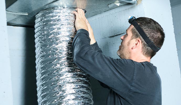 Technician installing flexible duct connection