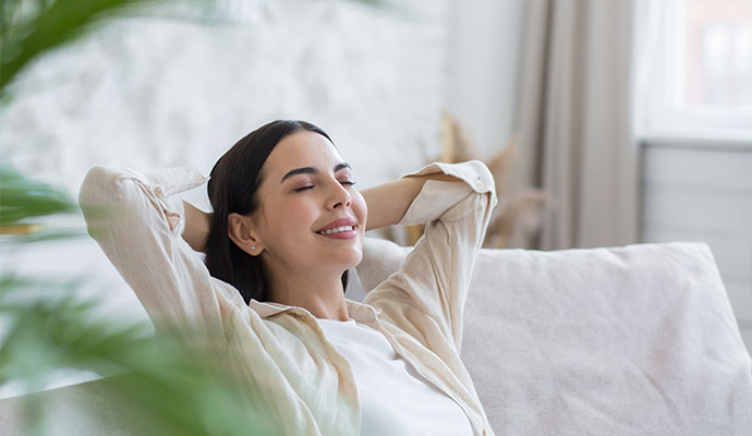 Woman relaxing at home enjoying fresh air