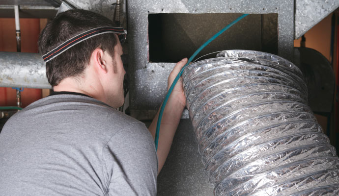 professional worker replacing duct pipe