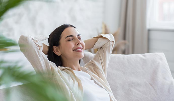 Woman sitting on sofa and relaxing in living room