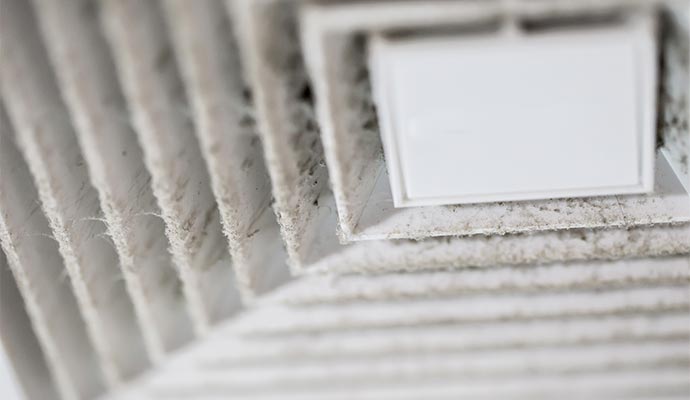 Excess dust around air vents indicating duct leaks.