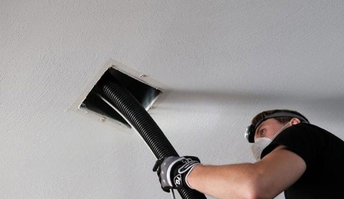 A professional fogging in a residential duct vent