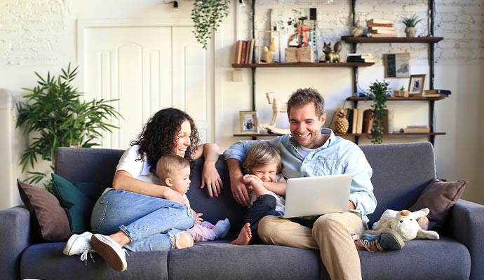 Parents and their children relaxing at home