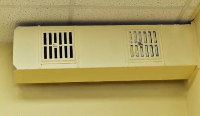 Ceiling air duct with visible dust buildup in a building