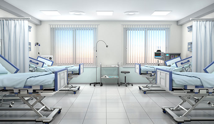 Clean hospital ward with multiple empty beds