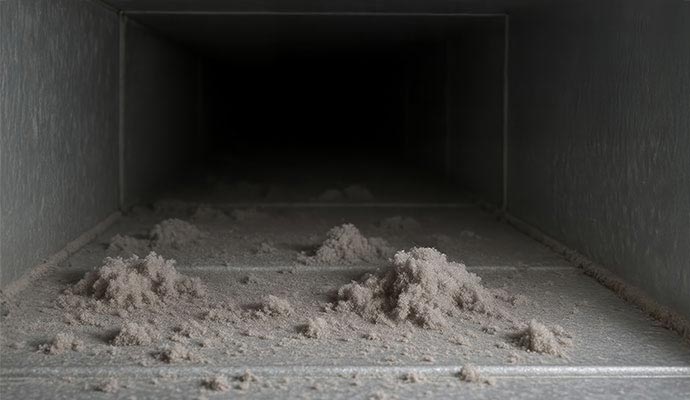 Heavy dust buildup inside dirty air ducts.
