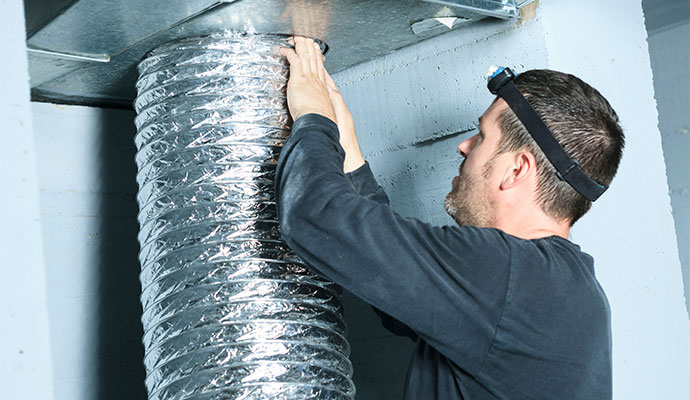 Technician installing flexible air duct