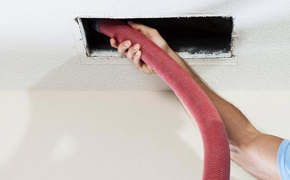 Professional worker cleaning duct