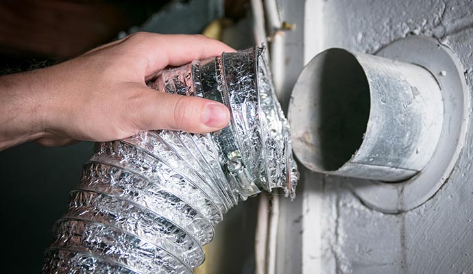 Technician re-installing air vent after cleaning