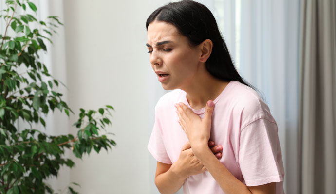 Woman coughing from indoor air allergens