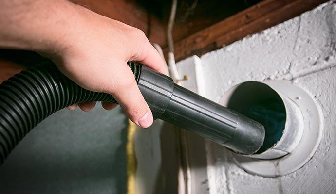 worker is cleaning dryer vent